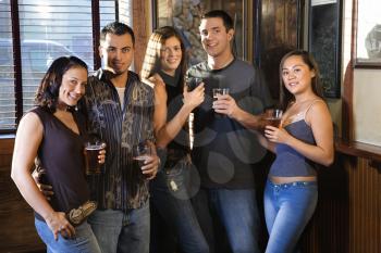Royalty Free Photo of a Group of Young Friends Hanging Out in a Pub and Drinking Beer