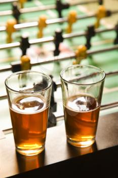 Royalty Free Photo of Two Glasses of Beer on a Foosball Table