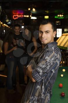 Royalty Free Photo of a Smiling Man Next to a Billiards Table at a Pub