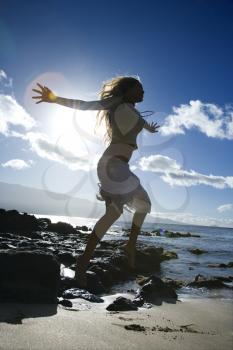 Royalty Free Photo of a Woman Jumping on a Beach in Maui Hawaii