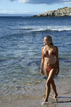 Royalty Free Photo of a Young Woman in a Bikini Walking on a Beach in Maui Hawaii