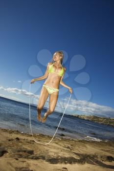Royalty Free Photo of a Woman in a Bikini Jumping Rope on a Beach in Maui Hawaii