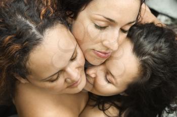 Royalty Free Photo of Three Nude Brunette Women Embracing Each Other With Eyes Closed