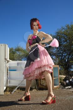 Royalty Free Photo of a Young Female House Cleaning in a Junkyard