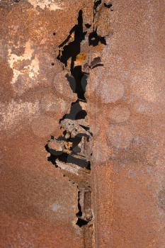 Royalty Free Photo of a Close-up of an Old Rusted Car With a Crack Down the Middle