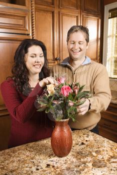 Royalty Free Photo of a Couple Arranging Flowers Together