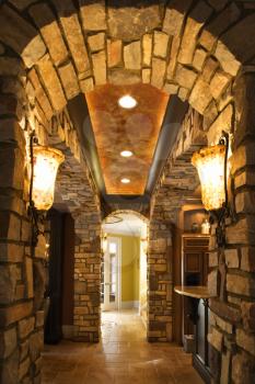 Royalty Free Photo of a Foyer Through a Stone Archway in an Affluent Home