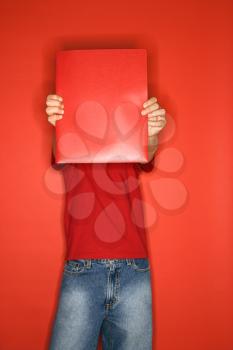 Royalty Free Photo of a Boy Holding out a Red Binder