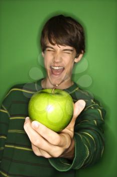 Royalty Free Photo of a Teen Boy Holding an Apple