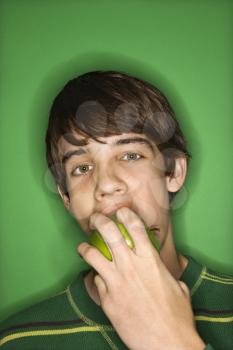 Royalty Free Photo of a Teen Boy Biting an Apple
