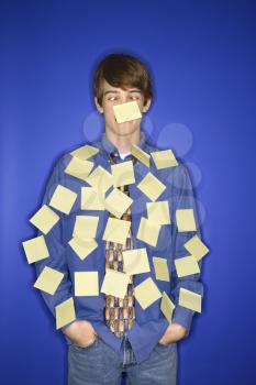 Royalty Free Photo of a Teenage Boy Covered With Blank Sticky Notes