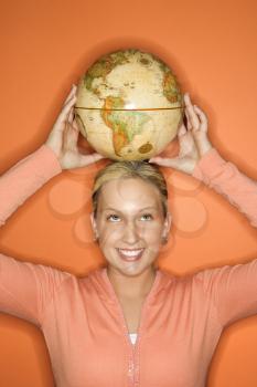 Royalty Free Photo of a Teen Girl holding a Globe 