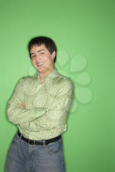 Royalty Free Photo of a Teen Boy Smiling With Crossed Arms Standing 