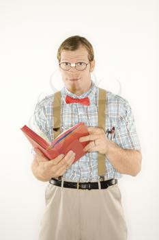 Royalty Free Photo of a Man Dressed Like a Nerd Reading a Book