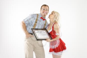 Royalty Free Photo of a Man Receiving a Kiss and a Certificate From a Woman