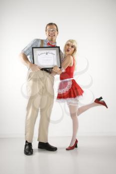 Royalty Free Photo of a Nerdy Man Holding a Certificate With a Woman Beside Him