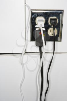 Royalty Free Photo of an Electrical Outlet With Multiple Plugs and Cords