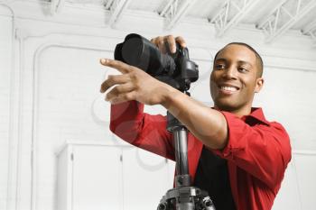 Royalty Free Photo of an African American Young Male Photographing in Studio