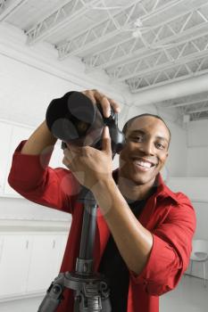 Royalty Free Photo of a Young Male Photographer Posing in a Studio