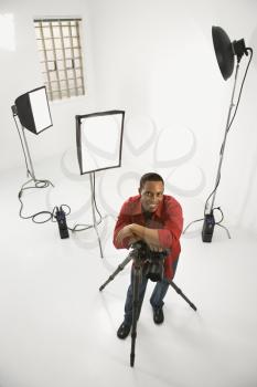 Royalty Free Photo of a Young  Photographer Posing in a Studio