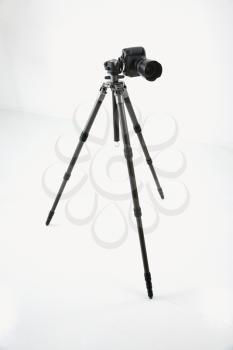 Royalty Free Photo of a Studio Shot of a Camera and Tripod