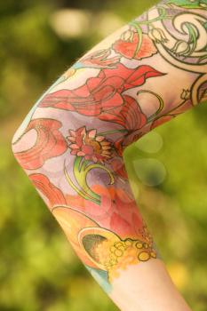 Royalty Free Photo of a Close-up of Floral Tattoos on the Arm of a Woman