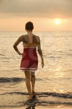 Royalty Free Photo of an Attractive Tattooed Woman on a Beach at Sunset in Maui, Hawaii, USA