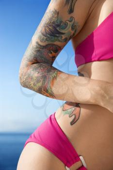Royalty Free Photo of a Tattooed Woman in a Bikini With Pacific Ocean in the Background in Maui, Hawaii, USA