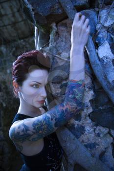 Royalty Free Photo of a Portrait of a Tattooed Woman Next to a Concrete Wall in Maui, Hawaii, USA