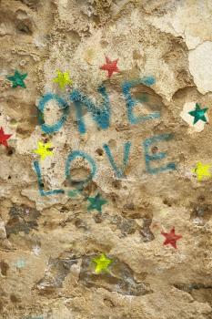 Royalty Free Photo of a Concrete Wall With Graffiti Stating 'One Love'