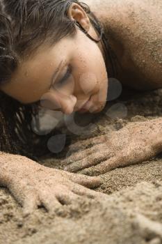 Royalty Free Photo of a Woman Lying in Sand