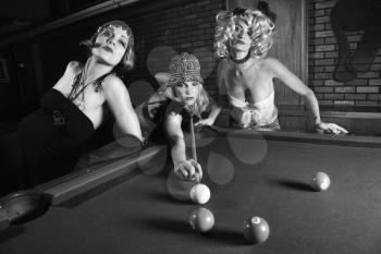 Royalty Free Photo of Three Females Shooting Pool