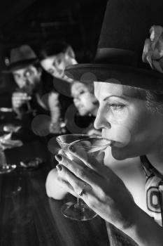Royalty Free Photo of a Woman Sitting at the Bar Drinking a Martini