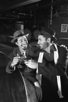 Royalty Free Photo of Men Sitting at a Bar Drinking