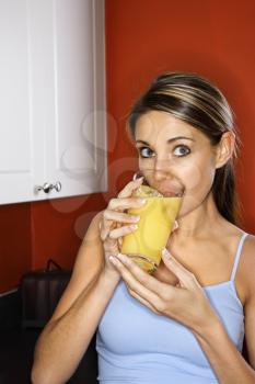 Royalty Free Photo of a Woman Drinking a Glass of Orange Juice
