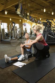 Royalty Free Photo of a Woman With a Personal Trainer at a Gym