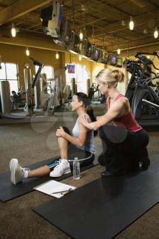 Royalty Free Photo of a Woman and Her Personal Trainer at the Gym