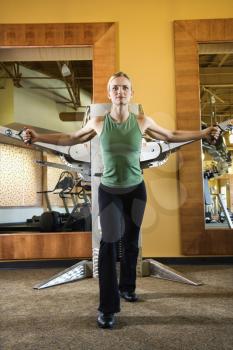 Royalty Free Photo of a Female Using Exercise Equipment at a Gym