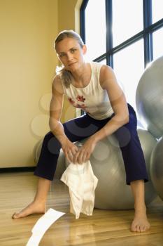 Royalty Free Photo of a Woman Sitting on an Exercise Ball in a Gym