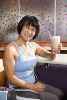 Royalty Free Photo of a Woman Sitting at a Table in a Health Club Cafeteria