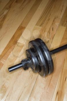 Royalty Free Photo of a Barbell With Weights on a Gym Floor