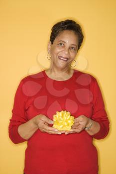 Royalty Free Photo of an Older African American Female Holding a Present
