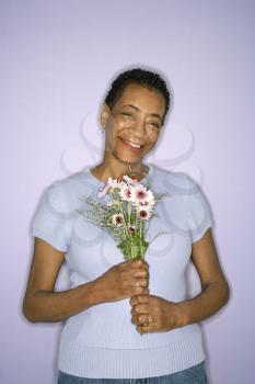 Royalty Free Photo of a Woman Holding Flowers
