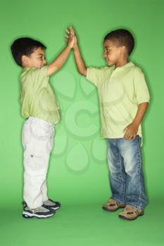 Royalty Free Photo of Children Giving Each Other a High Five