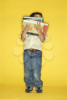 Royalty Free Photo of a Little Boy Holding a Stack of Books
