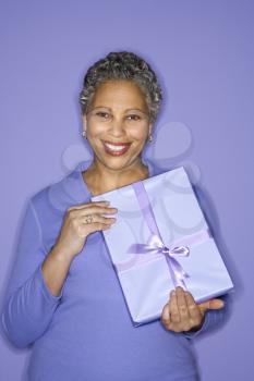 Royalty Free Photo of an Older Woman Holding a Present