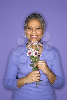 Royalty Free Photo of a Woman Holding Flowers
