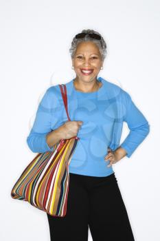 Royalty Free Photo of a Smiling Woman Holding a Purse