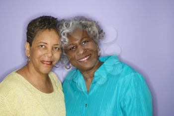 Mature adult African American females looking at viewer smiling.