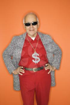 Royalty Free Photo of an Older Male Wearing a Money Sign Necklace and Sunglasses